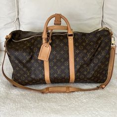 Classic Monogram Canvas Duffle Bag, Luxury Monogram Canvas Travel Bag For Formal Occasions, Brown Monogram Canvas Duffle Bag, Elegant Monogram Canvas Travel Bag With Leather Trim, Designer Formal Duffle Bag With Dust Bag, Elegant Monogram Canvas Travel Bag, Vintage Monogram Canvas Gold Bag, Vintage Gold Monogram Canvas Bag, Elegant Brown Monogram Canvas Travel Bag