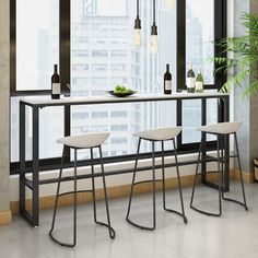 three stools and a table in front of a large window with cityscape