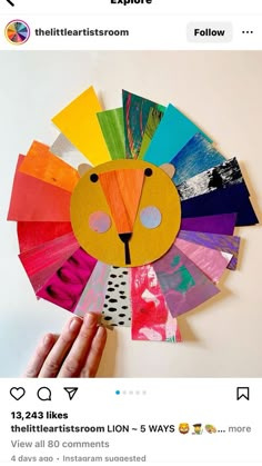 someone is making a paper lion mask out of colored construction paper and then it's made with scissors