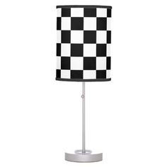 a black and white checkered lamp on a stand