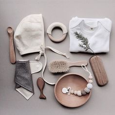 the contents of a baby's gift set are laid out on a gray surface