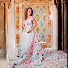 a woman in a wedding dress posing for a photo