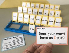 a person holding up a card with words on it next to a keyboard and some cards