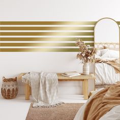 a bedroom with gold and white stripes on the wall