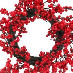 a wreath with red berries hanging from it