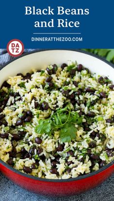 black beans and rice in a red pan with green garnish on the side