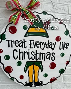 a sign that says treat everyday like christmas on the side of a brick wall with a red bow