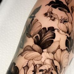 a close up of a person's arm with flowers on it