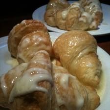 some croissants are sitting on white plates