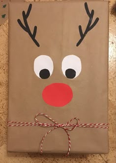 a brown paper bag with reindeer's nose on it