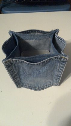 a pair of blue jeans sitting on top of a white counter