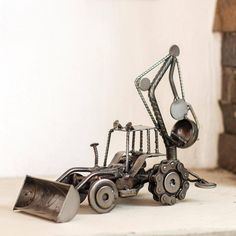 a metal sculpture of a bulldozer on the ground