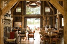 a living room filled with furniture and a fire place in the middle of a room