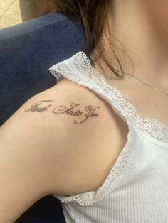 a woman with a tattoo on her shoulder that says, i am the one to you