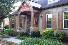 a house that has some bushes in front of it