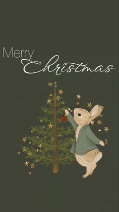 a merry christmas card with a white rabbit climbing up the side of a christmas tree