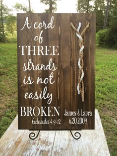 a wooden sign that says, a cord of three strands is not easily broken