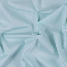 a close up view of a light blue fabric