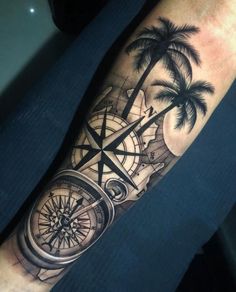 a man's arm with a compass, palm trees and a map on it