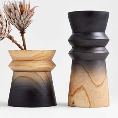 two wooden vases sitting next to each other