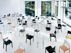 a room filled with lots of different colored chairs