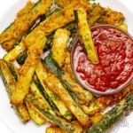 asparagus fries with ketchup on a white plate