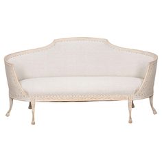 a white couch sitting on top of a wooden frame