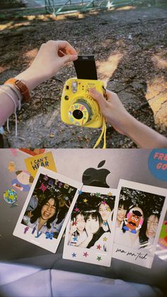 a person taking pictures with an apple camera and some stickers on the table next to them