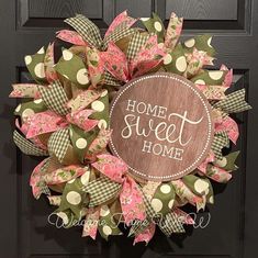 a pink and green wreath that says home sweet home