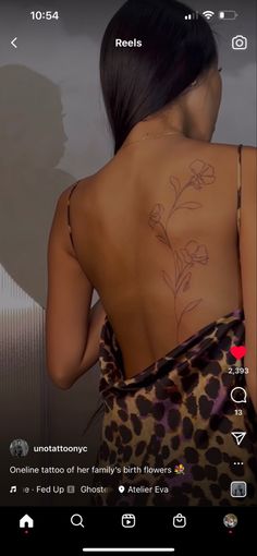 the back of a woman's body with tattoos on her upper and lower back