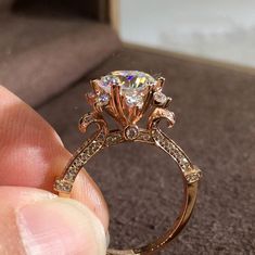 a person is holding a diamond ring in their hand