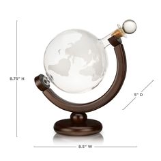 a glass globe on a wooden stand is shown with measurements for the size and shape