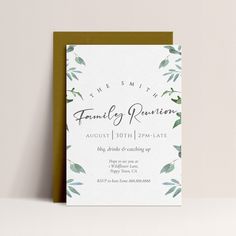 a white card with green leaves on it and the words family reunion written in black