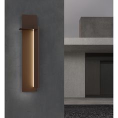 a wall light that is on the side of a building next to a concrete wall