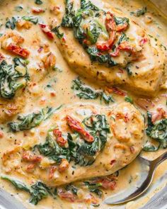 chicken with spinach and tomato sauce in a skillet