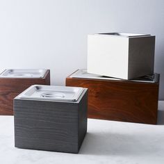 three wooden boxes sitting on top of each other