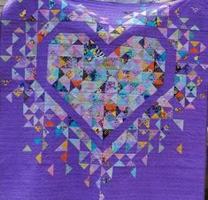 a purple quilt with a heart on it