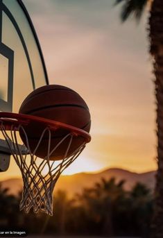 a basketball going through the hoop at sunset