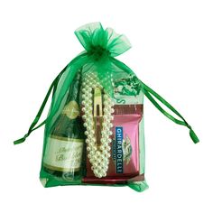 a green organ bag filled with wine and other items to be used as a gift