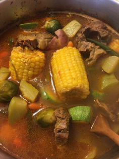 a pot filled with stew and vegetables on top of a stove