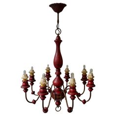 a red chandelier hanging from the ceiling with five lights on each arm and one light in the middle