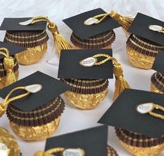 graduation cupcakes in gold foil wrapped in black paper and decorated with golden tassels