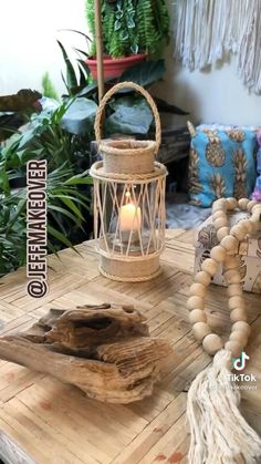 a wooden table topped with a candle next to a tasseled piece of wood