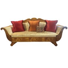 a wooden couch with many pillows on it's back and arm rests against a white background