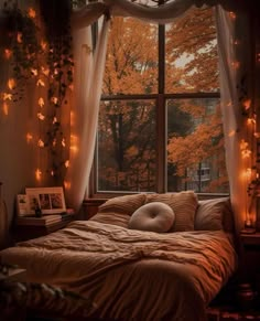 a bed sitting under a window covered in lights