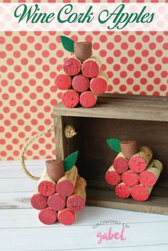 two wine cork apples sitting on top of a wooden box