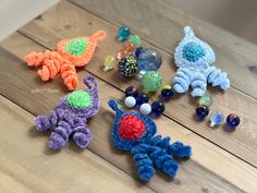 several crocheted toys sitting on top of a wooden table