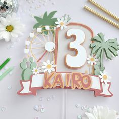 a birthday cake with the number thirteen on it and flowers around it, surrounded by confetti