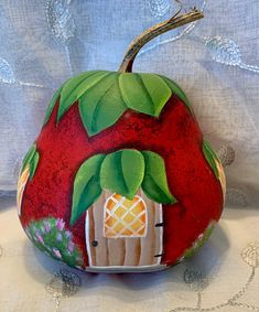 a painted pumpkin sitting on top of a table