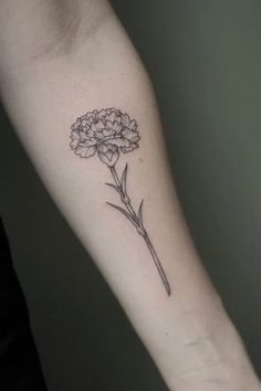 a single flower tattoo on the arm